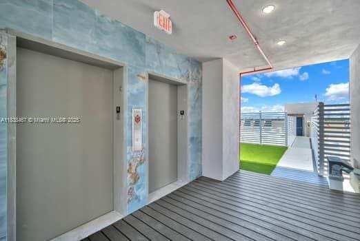 1850 Monroe Unit 301, Hollywood, FL 33020 - hallway with elevator and wood finished floors