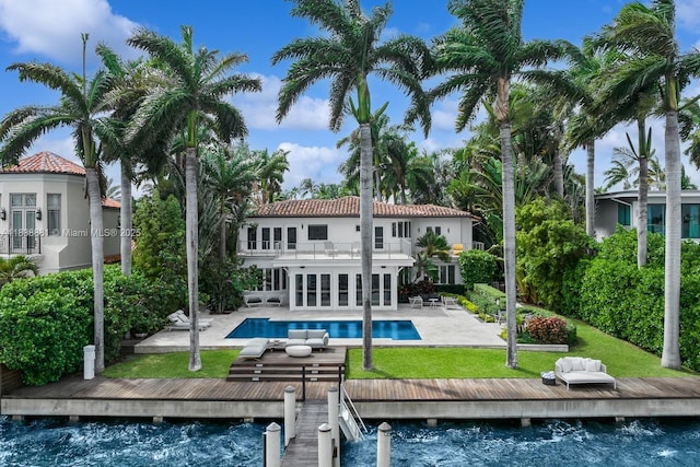 315 E Rivo Alto Dr, Miami Beach, FL 33139 - back of property featuring a balcony, a patio area, an outdoor pool, french doors, and a yard
