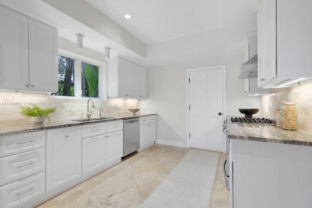 315 E Rivo Alto Dr, Miami Beach, FL 33139 - kitchen with stainless steel appliances, white cabinetry, light stone countertops, backsplash, and recessed lighting