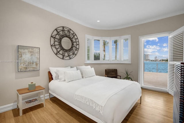 315 E Rivo Alto Dr, Miami Beach, FL 33139 - bedroom featuring access to exterior, ornamental molding, wood finished floors, a water view, and recessed lighting