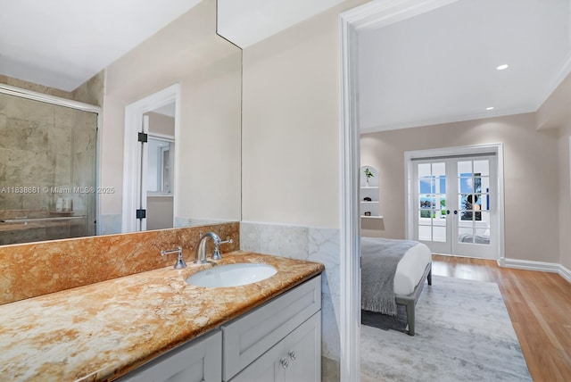 315 E Rivo Alto Dr, Miami Beach, FL 33139 - full bathroom featuring wood finished floors, french doors, vanity, and a stall shower