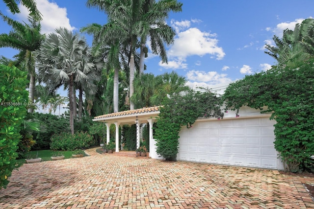 315 E Rivo Alto Dr, Miami Beach, FL 33139 - view of patio / terrace featuring decorative driveway and a garage