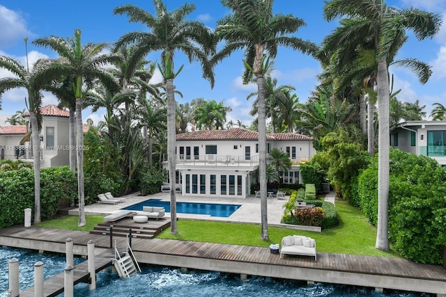 315 E Rivo Alto Dr, Miami Beach, FL 33139 - back of house with a balcony, a patio, a yard, and an outdoor pool