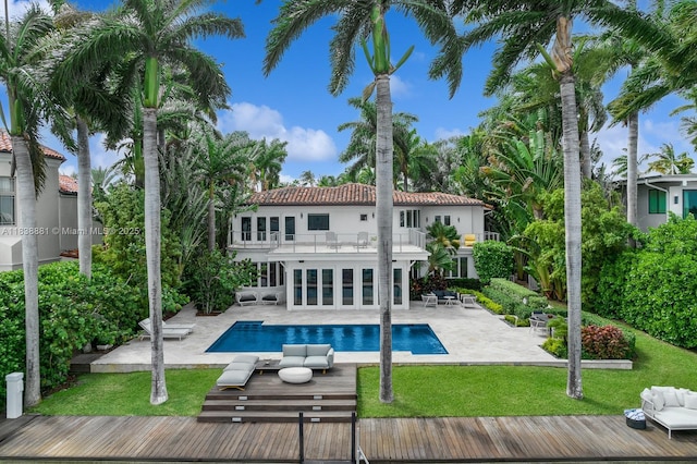 315 E Rivo Alto Dr, Miami Beach, FL 33139 - rear view of property with a balcony, an outdoor hangout area, a yard, and an outdoor pool