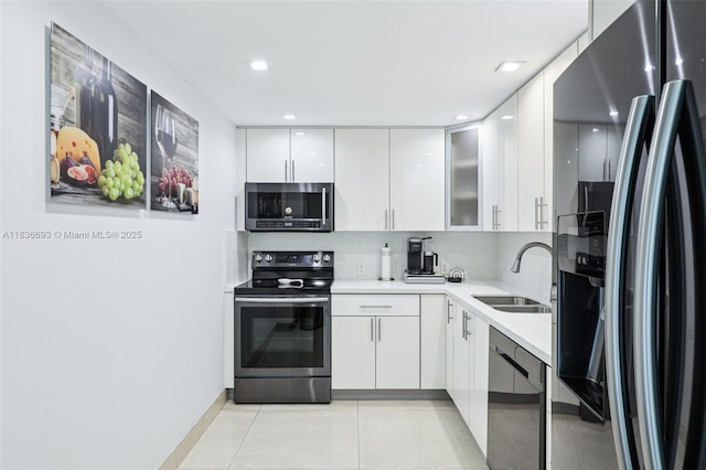 20379 W Country Club Dr Unit 1436, Aventura, FL 33180 - kitchen with appliances with stainless steel finishes, light tile patterned floors, light countertops, white cabinets, and modern cabinets