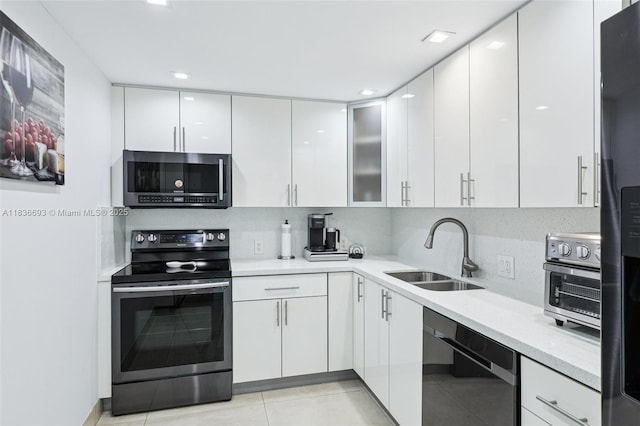 20379 W Country Club Dr Unit 1436, Aventura, FL 33180 - kitchen with stainless steel appliances, white cabinets, modern cabinets, light countertops, and light tile patterned floors