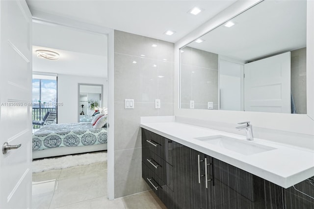 20379 W Country Club Dr Unit 1436, Aventura, FL 33180 - bathroom featuring vanity, ensuite bath, tile walls, and tile patterned flooring