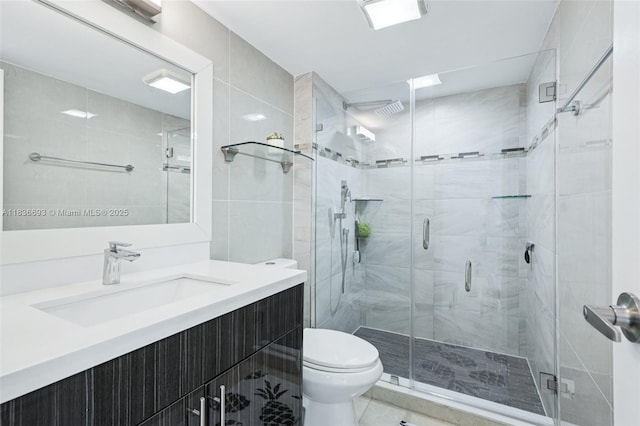20379 W Country Club Dr Unit 1436, Aventura, FL 33180 - bathroom featuring vanity, a shower stall, tile patterned floors, and tile walls