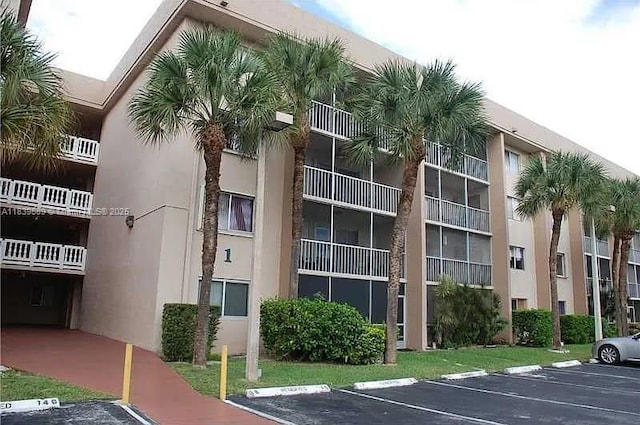 17000 NW 67th Ave Unit 206, Hialeah, FL 33015 - view of apartment building / complex with uncovered parking