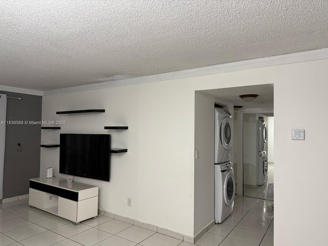 17000 NW 67th Ave Unit 206, Hialeah, FL 33015 - unfurnished living room with stacked washing machine and dryer, crown molding, a textured ceiling, and light tile patterned flooring