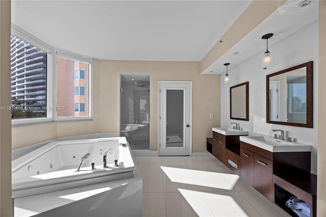 300 S Pointe Dr Unit 501, Miami Beach, FL 33139 - bathroom featuring a whirlpool tub, two vanities, and tile patterned floors