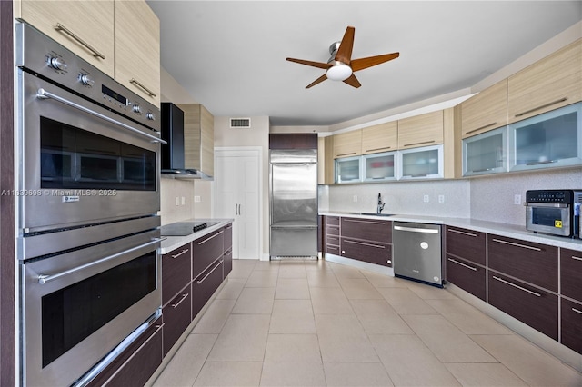 300 S Pointe Dr Unit 501, Miami Beach, FL 33139 - kitchen with appliances with stainless steel finishes, wall chimney range hood, modern cabinets, light countertops, and ceiling fan