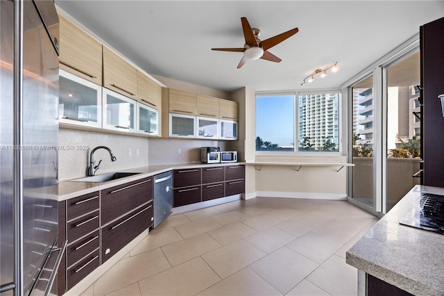 300 S Pointe Dr Unit 501, Miami Beach, FL 33139 - kitchen with stainless steel appliances, ceiling fan, light tile patterned floors, dark brown cabinetry, and modern cabinets