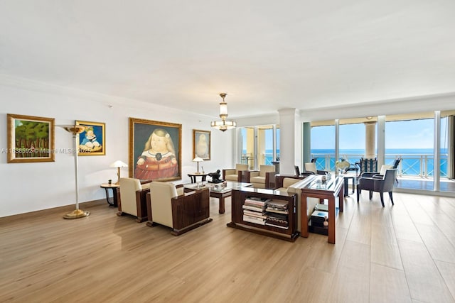 445 Grand Bay Dr Unit 1011, Key Biscayne, FL 33149 - living area with light wood-style floors, a chandelier, a water view, and ornamental molding