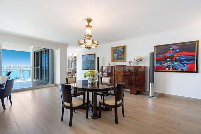 445 Grand Bay Dr Unit 1011, Key Biscayne, FL 33149 - dining space with light wood-type flooring and a chandelier