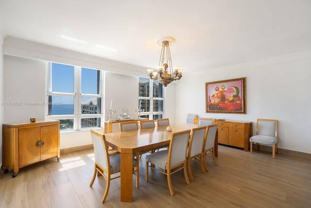 445 Grand Bay Dr Unit 1011, Key Biscayne, FL 33149 - dining space with a chandelier, light wood-style floors, and ornamental molding