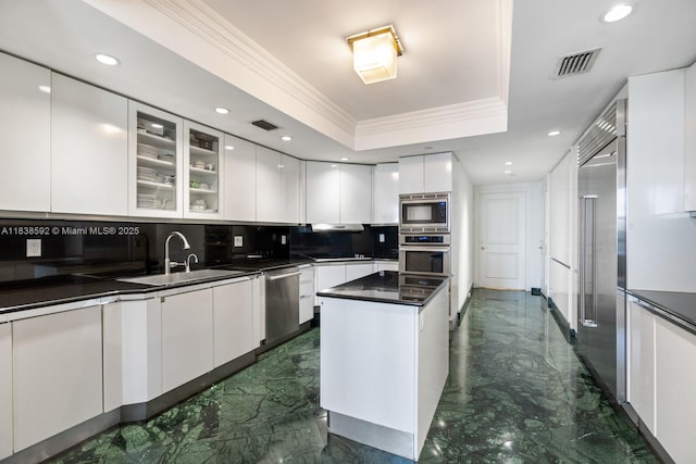 445 Grand Bay Dr Unit 1011, Key Biscayne, FL 33149 - kitchen with built in appliances, modern cabinets, dark marble finish flooring, ornamental molding, and dark countertops
