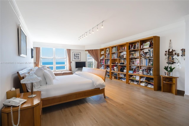 445 Grand Bay Dr Unit 1011, Key Biscayne, FL 33149 - bedroom featuring crown molding, wood finished floors, and rail lighting