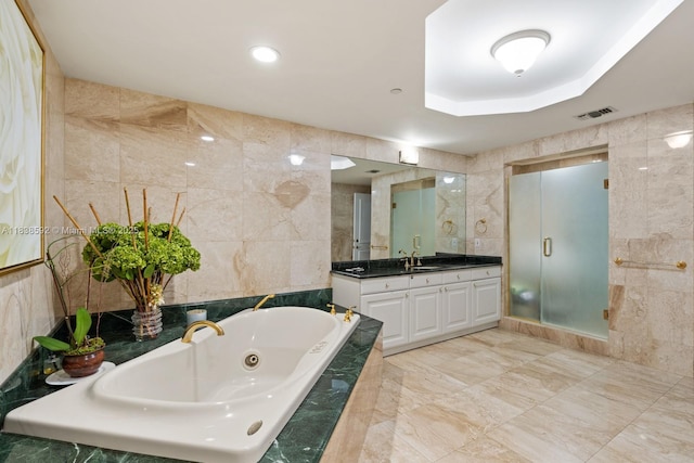 445 Grand Bay Dr Unit 1011, Key Biscayne, FL 33149 - bathroom with tile walls, vanity, a whirlpool tub, a shower stall, and marble finish flooring