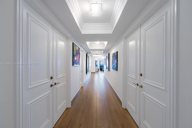 445 Grand Bay Dr Unit 1011, Key Biscayne, FL 33149 - hallway featuring a raised ceiling, ornamental molding, and wood finished floors