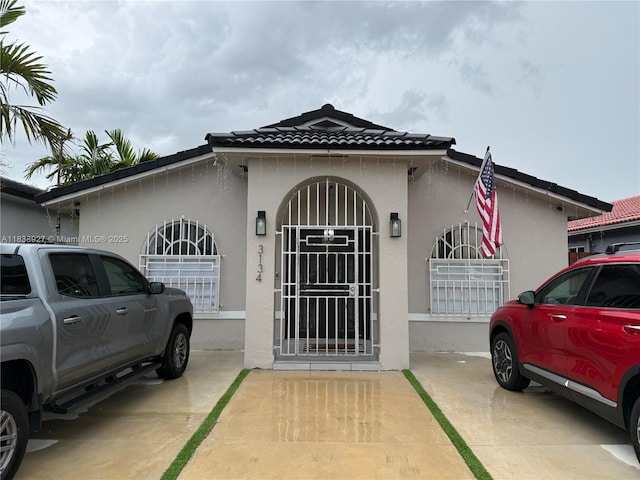 3134 W 70th Ter, Hialeah, FL 33018 - view of side of property with stucco siding and a tiled roof