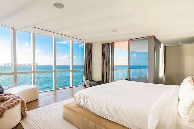 17475 Collins Ave Unit 1001, Sunny Isles Beach, FL 33160 - bedroom with a wall of windows, a water view, wood finished floors, and access to outside