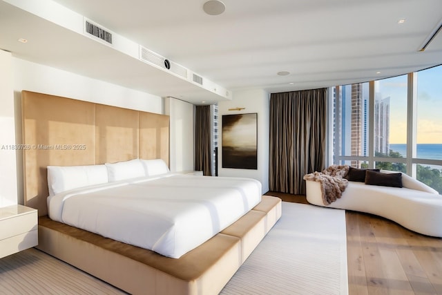 17475 Collins Ave Unit 1001, Sunny Isles Beach, FL 33160 - bedroom featuring wood finished floors, a water view, and expansive windows