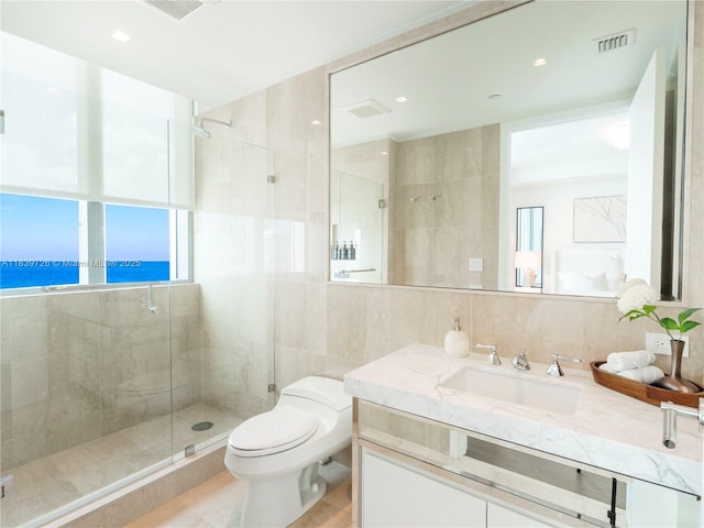 17475 Collins Ave Unit 1001, Sunny Isles Beach, FL 33160 - bathroom with tile walls, a shower stall, vanity, plenty of natural light, and tile patterned flooring