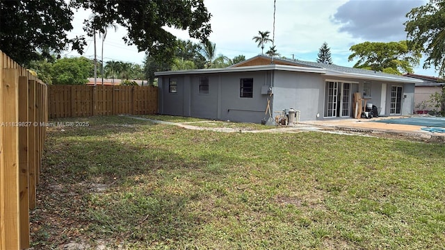 3851 NW 3rd Ter, Deerfield Beach, FL 33064 - rear view of property with a fenced backyard, a patio area, and stucco siding