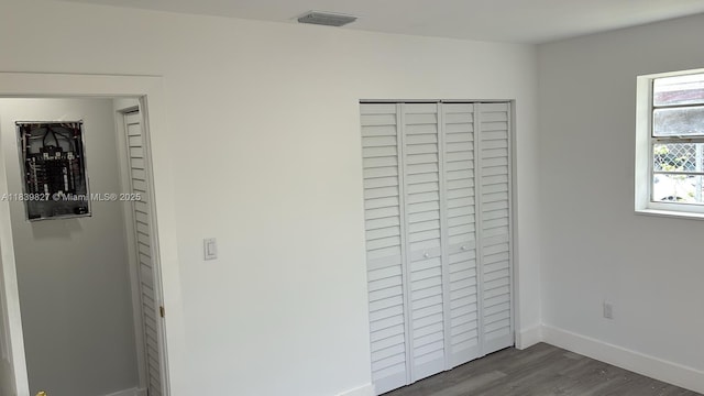 3851 NW 3rd Ter, Deerfield Beach, FL 33064 - unfurnished bedroom with dark wood-style floors and a closet