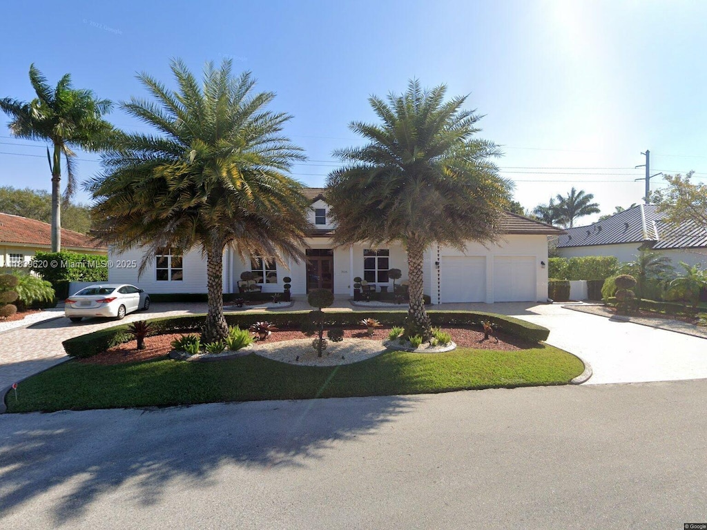 7635 SW 84th Ct, Miami, FL 33143 - view of front of home with concrete driveway, a garage, and stucco siding
