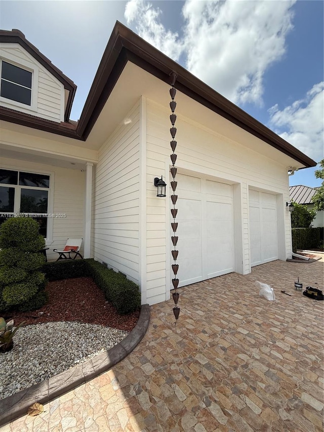 7635 SW 84th Ct, Miami, FL 33143 - view of side of home featuring decorative driveway and a garage