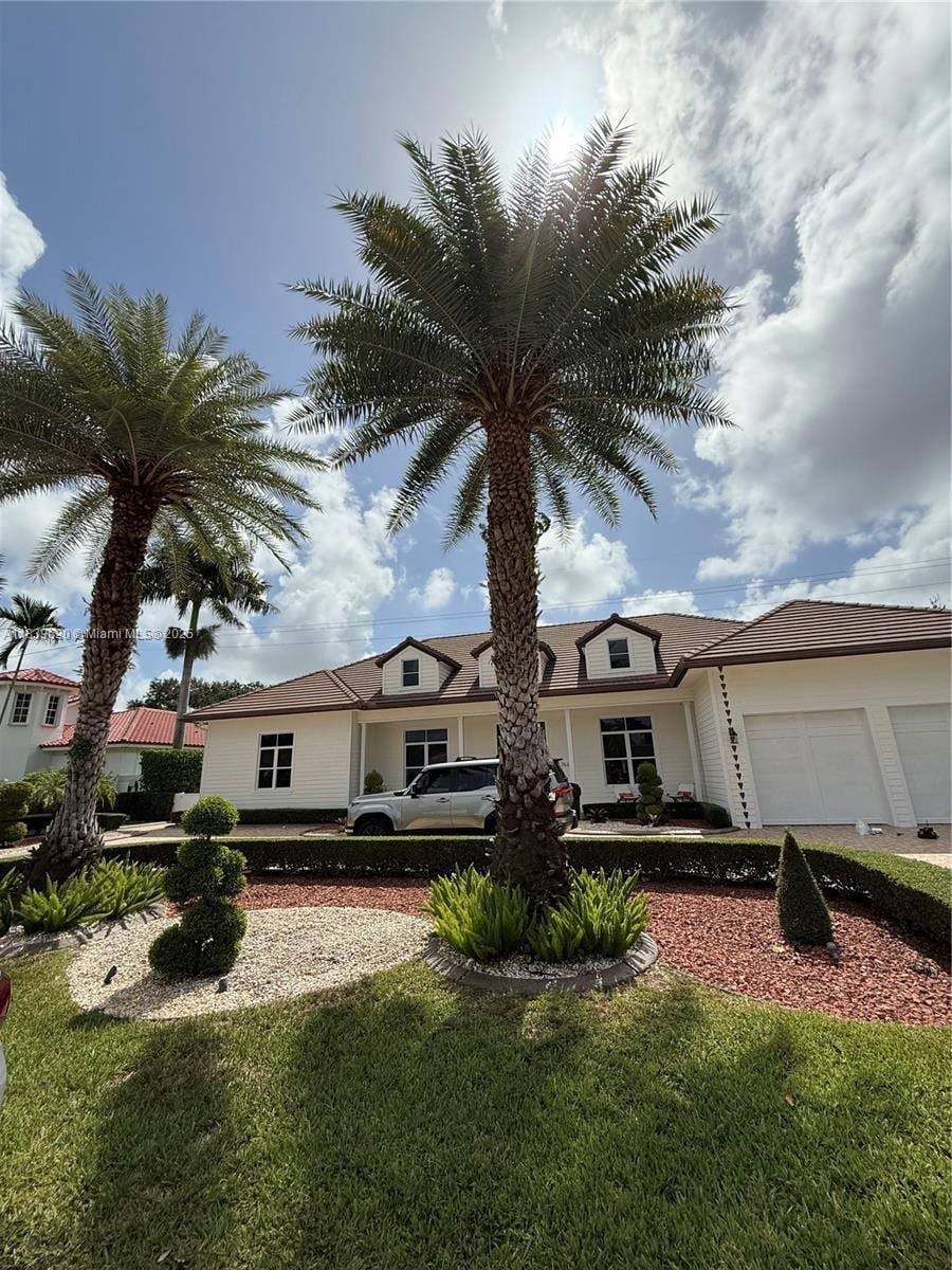 7635 SW 84th Ct, Miami, FL 33143 - view of front facade with an attached garage and a front yard
