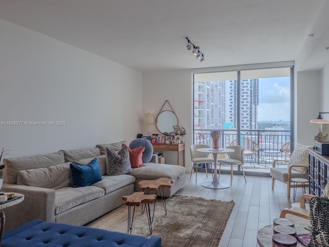 999 SW 1st Ave Unit 1609, Miami, FL 33130 - living room featuring light wood finished floors, floor to ceiling windows, rail lighting, and a view of city