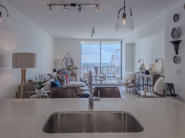 999 SW 1st Ave Unit 1609, Miami, FL 33130 - kitchen featuring floor to ceiling windows, open floor plan, track lighting, light countertops, and decorative light fixtures