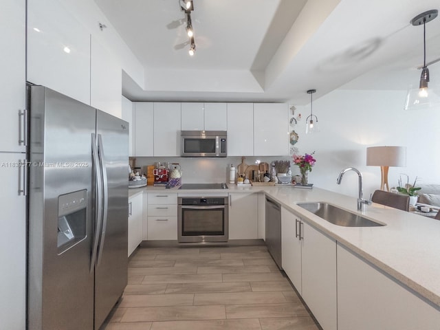 999 SW 1st Ave Unit 1609, Miami, FL 33130 - kitchen with appliances with stainless steel finishes, white cabinetry, decorative light fixtures, light wood-style floors, and modern cabinets