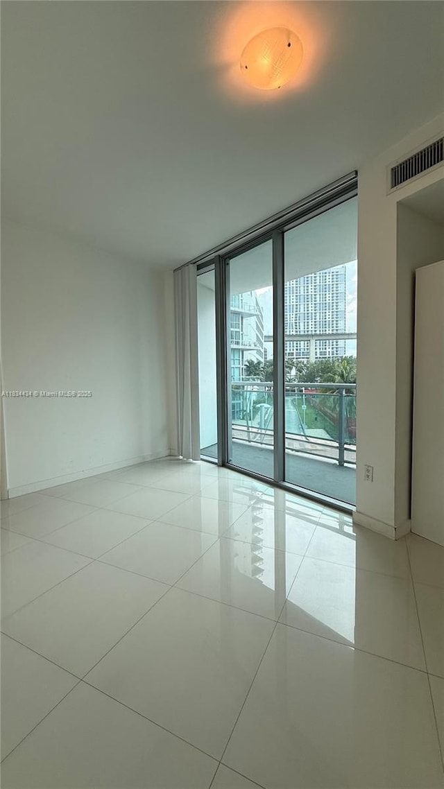350 S Miami Ave Unit 312, Miami, FL 33130 - tiled empty room with expansive windows and baseboards