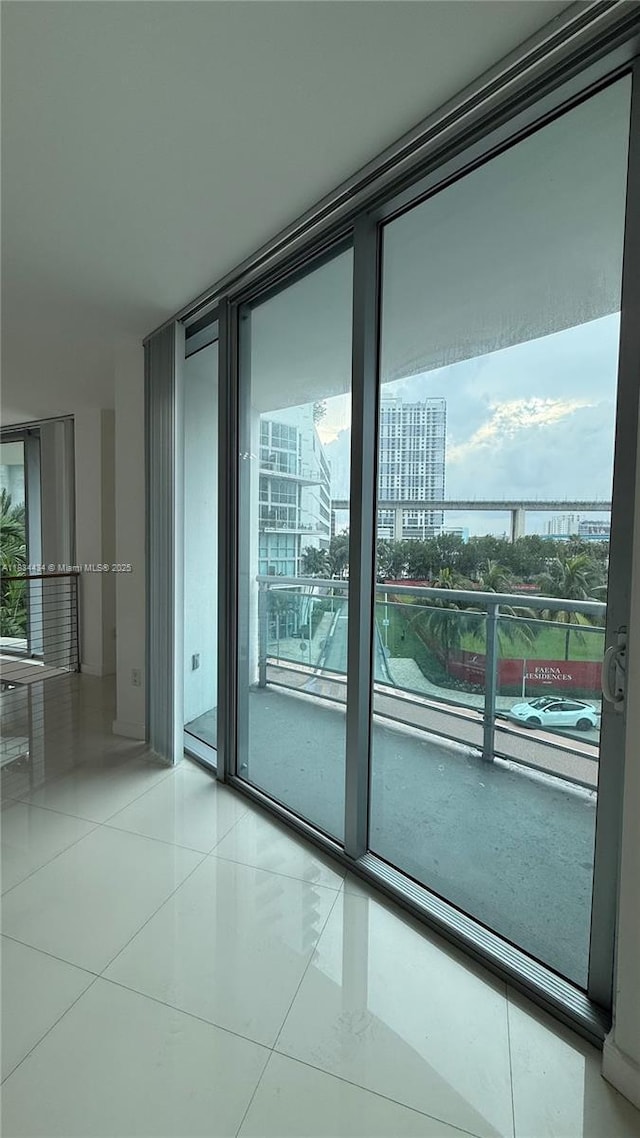 350 S Miami Ave Unit 312, Miami, FL 33130 - unfurnished room with plenty of natural light, expansive windows, light tile patterned flooring, and a city view