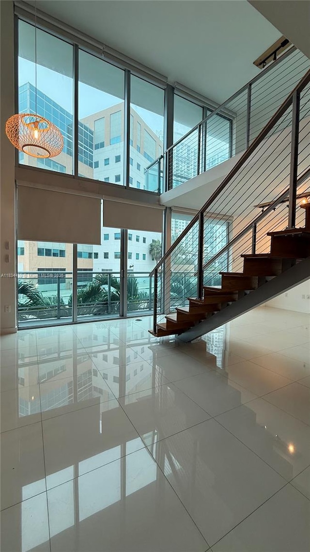 350 S Miami Ave Unit 302, Miami, FL 33130 - stairs with plenty of natural light, tile patterned flooring, and a high ceiling