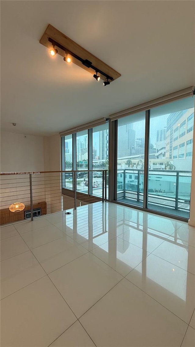 350 S Miami Ave Unit 302, Miami, FL 33130 - unfurnished room with rail lighting, tile patterned flooring, and floor to ceiling windows