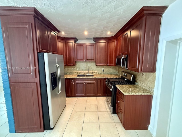 2406 N 28th Ave, Hollywood, FL 33020 - kitchen featuring appliances with stainless steel finishes, light tile patterned flooring, tasteful backsplash, and light stone counters
