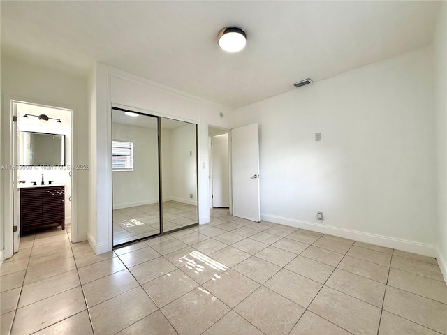 2406 N 28th Ave, Hollywood, FL 33020 - unfurnished bedroom featuring light tile patterned floors and a closet