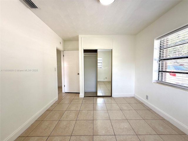 2406 N 28th Ave, Hollywood, FL 33020 - unfurnished bedroom featuring light tile patterned floors and a closet