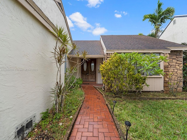 1440 Egret Rd, Homestead, FL 33035 - doorway to property with stucco siding and roof with shingles