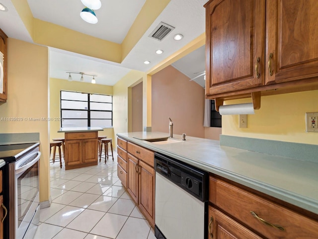 1440 Egret Rd, Homestead, FL 33035 - kitchen with dishwasher, stainless steel range with electric stovetop, brown cabinetry, light tile patterned floors, and recessed lighting