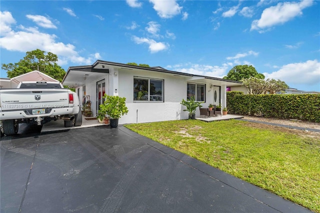 231 E 41st St, Hialeah, FL 33013 - ranch-style house featuring stucco siding, a front lawn, and driveway