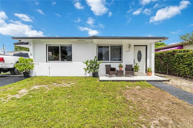 231 E 41st St, Hialeah, FL 33013 - view of front facade with a front lawn and stucco siding