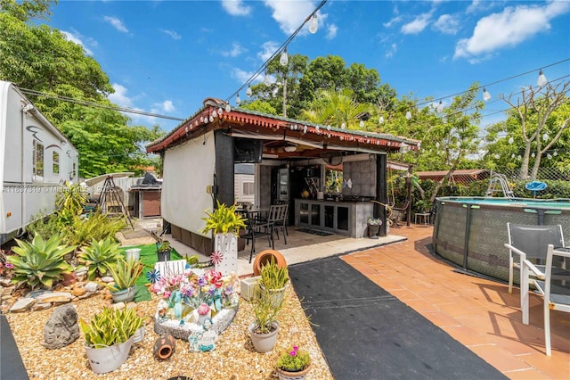 231 E 41st St, Hialeah, FL 33013 - rear view of house with a patio and an outdoor pool