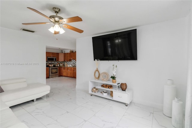 231 E 41st St, Hialeah, FL 33013 - living room featuring light marble finish floors and a ceiling fan