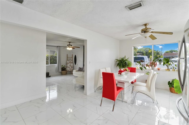 231 E 41st St, Hialeah, FL 33013 - dining space with ceiling fan, a textured ceiling, and marble finish flooring